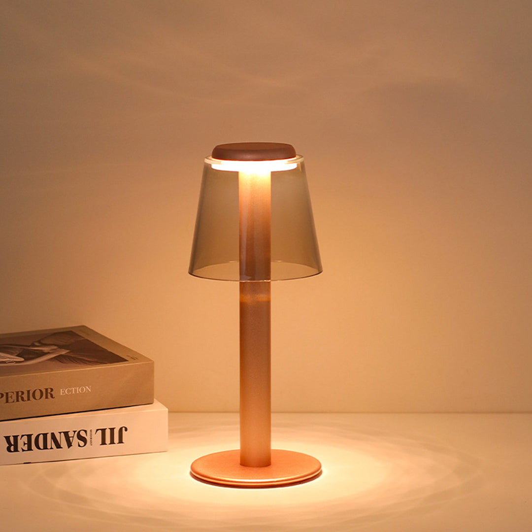 Elegant adjustable table lamp with warm copper glow illuminating books and workspace materials