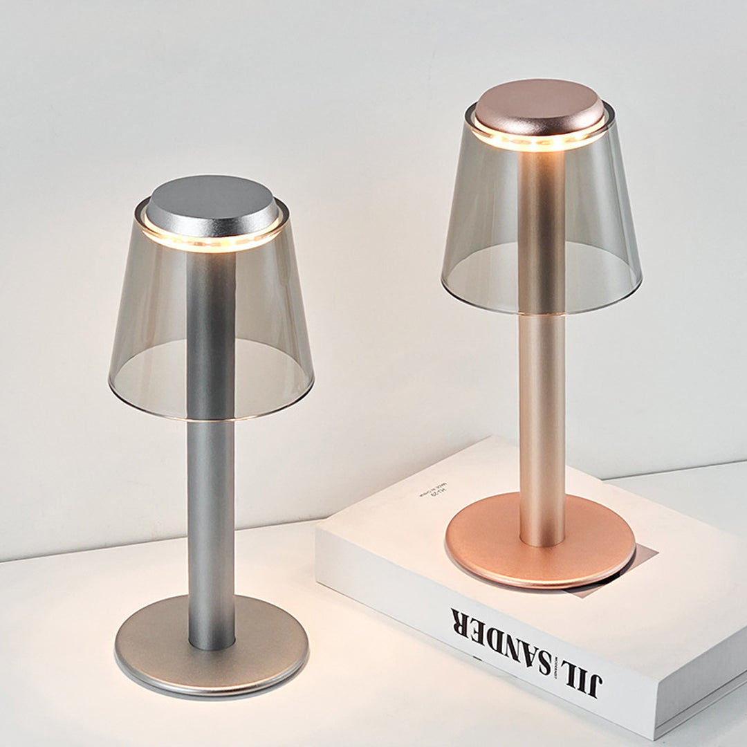 Elegant adjustable table lamp with warm copper glow illuminating books and workspace materials