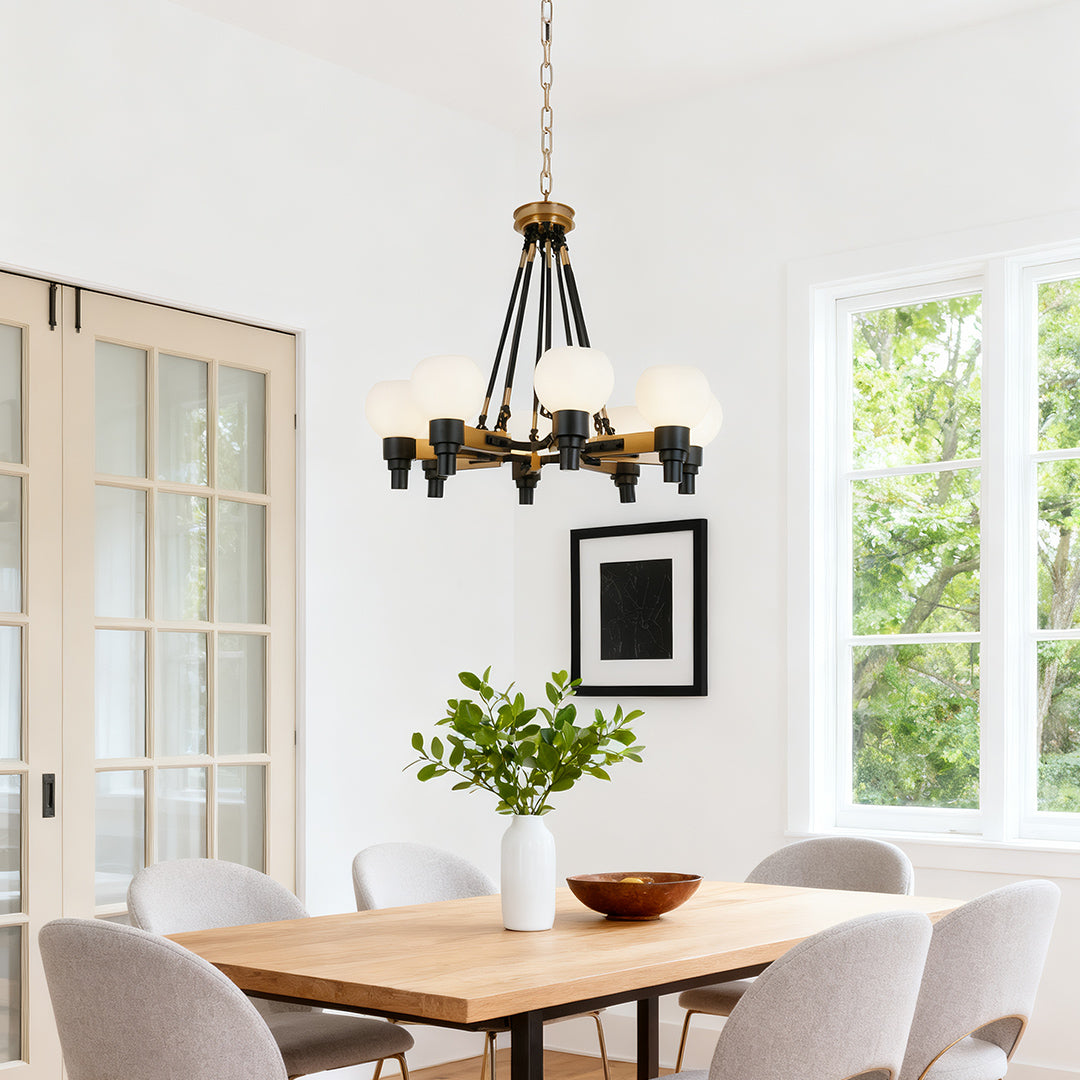 Elegant 8 light chandeliers providing warm ambient lighting in a traditional dining room setting with a large bookshelf and dark wood furniture.