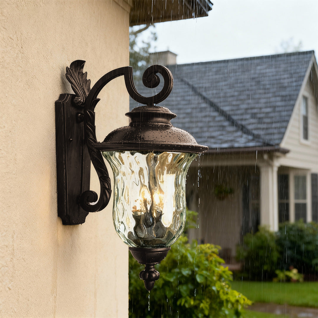Elegant black exterior wall light illuminating beige stucco facade with grey roof backdrop