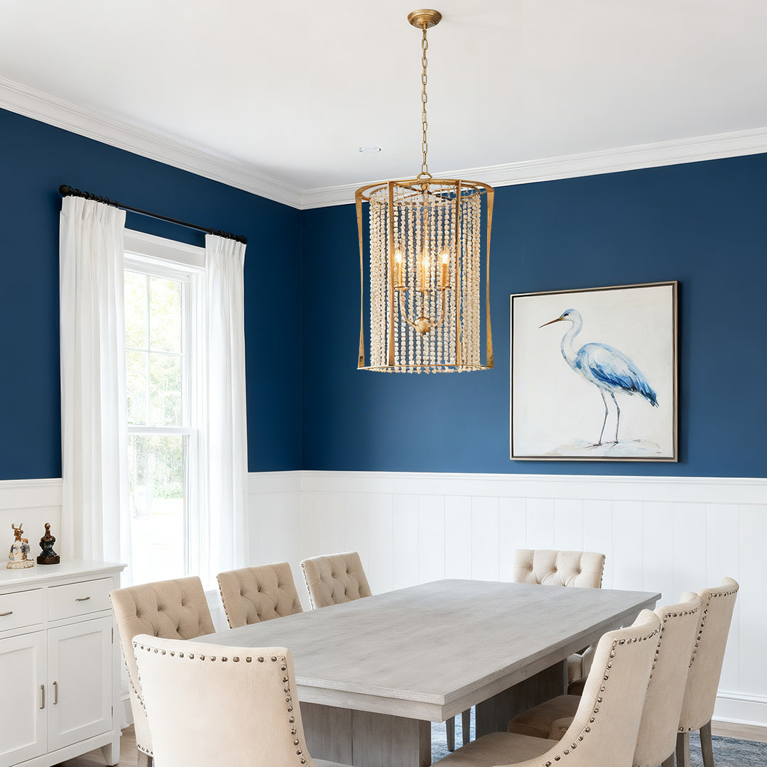 Stylish wood beaded chandelier with gold frame in a cozy dining room with blue walls