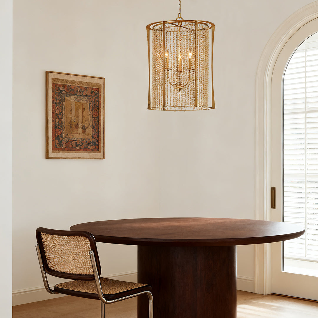 Modern wood beaded chandelier with gold frame in a stylish dining room with round table