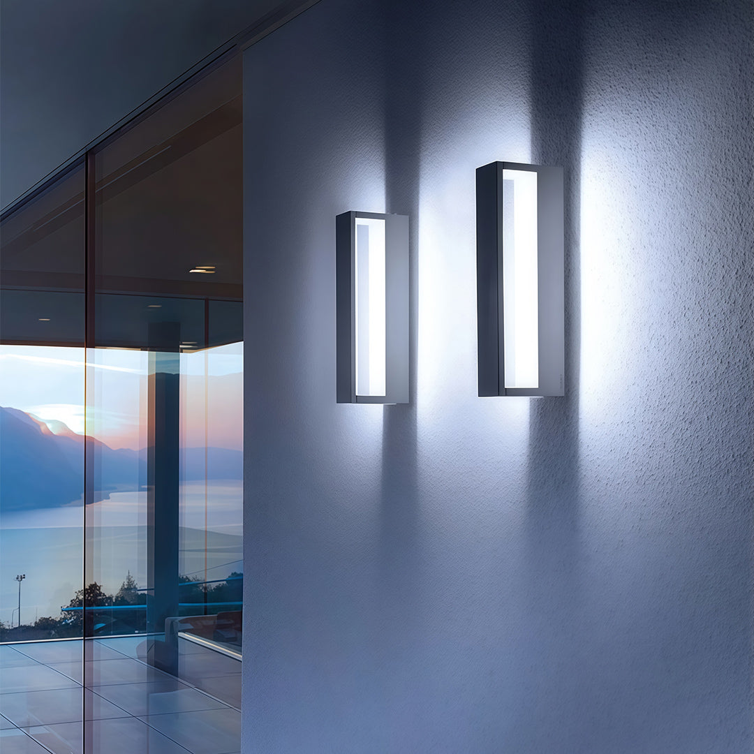 Elegant black sconces outdoor featuring glass shade chandelier design creating dramatic uplighting and downlighting on contemporary exterior wall.