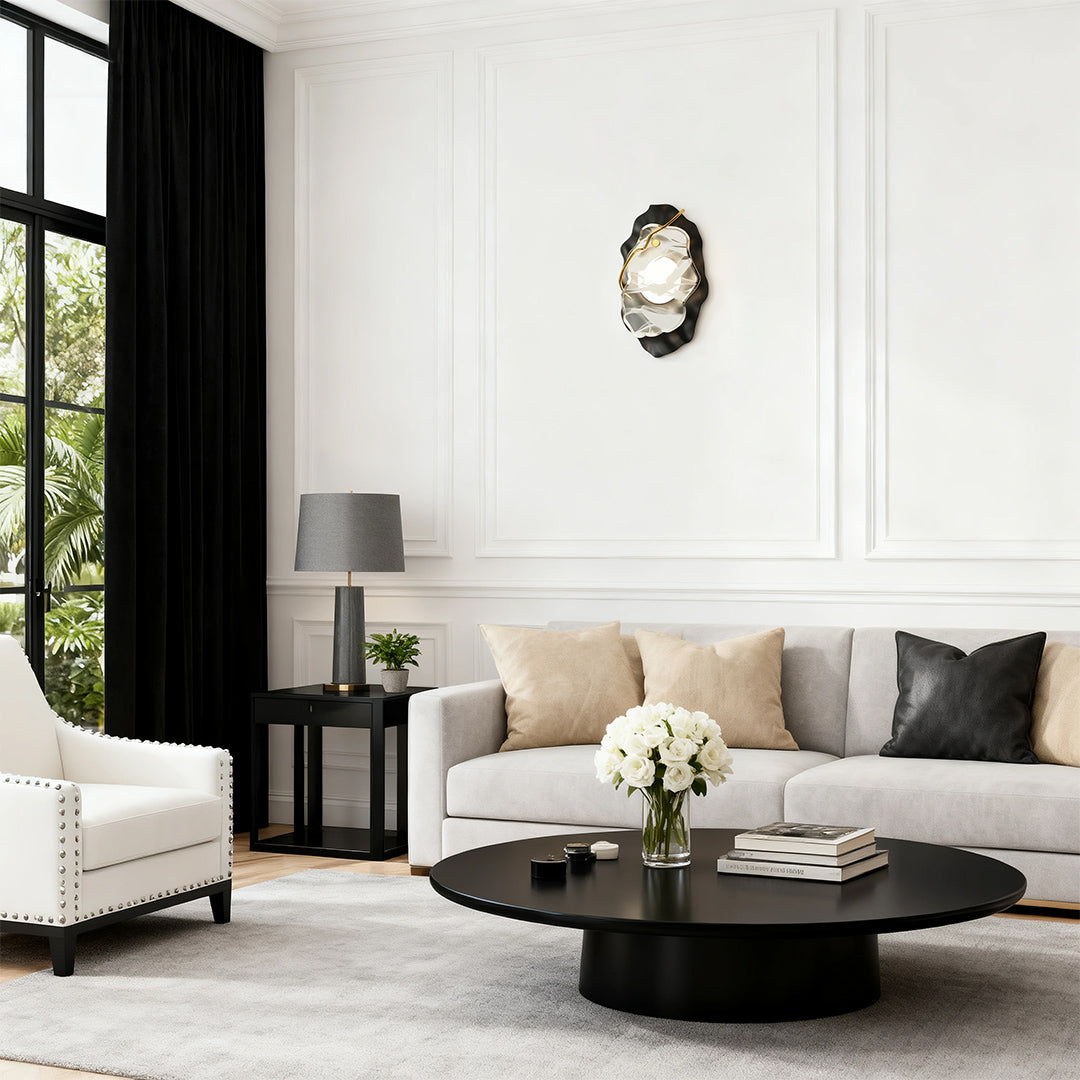 Elegant black wall light mounted on white paneled wall in minimalist living room with sofa
