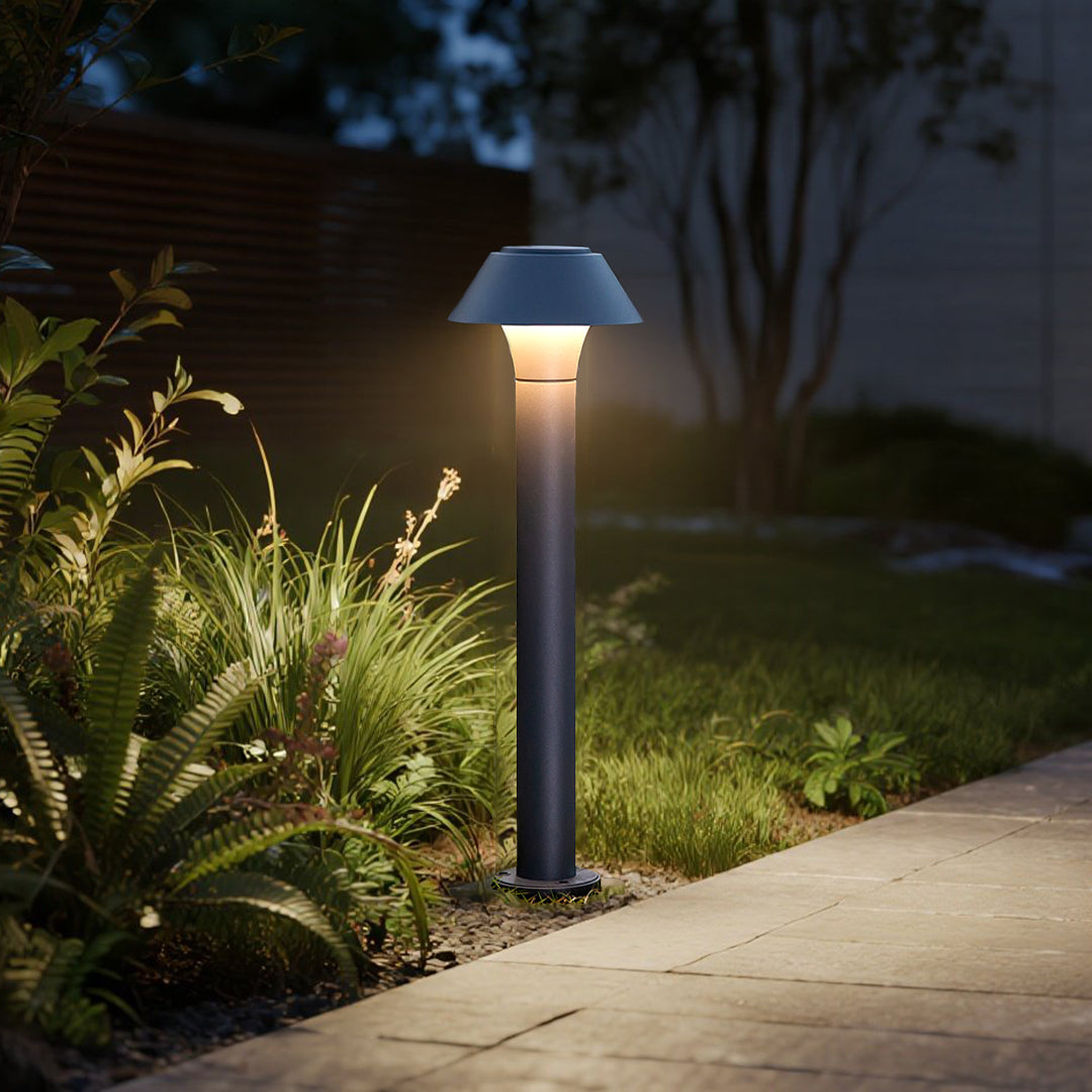 Elegant bollard lights lining concrete pathway with warm LED illumination in evening landscape