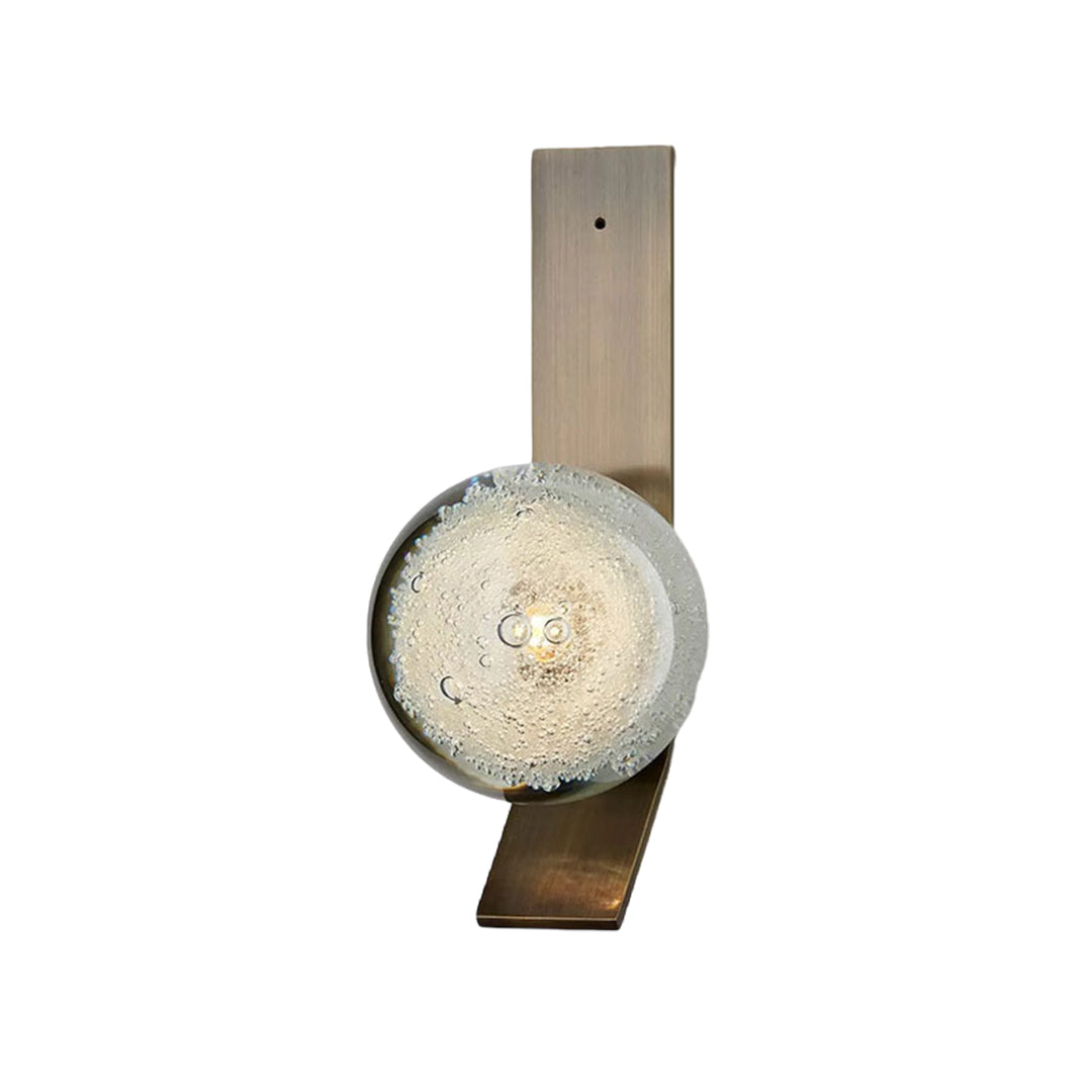 Elegant brass wall sconce with single frosted glass globe for refined ambient lighting