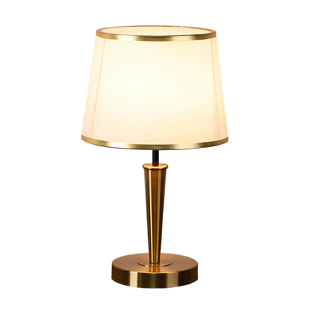Elegant brass table lamp featuring cream shade and polished gold base finish