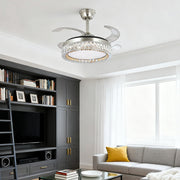 Elegant brushed nickel crystal ceiling fan with light over a modern media cabinet 