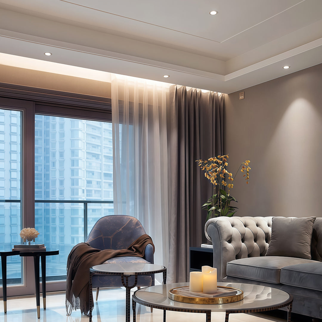 Elegant ceiling design combining cove lighting with recessed modern spotlights in a cozy living room.