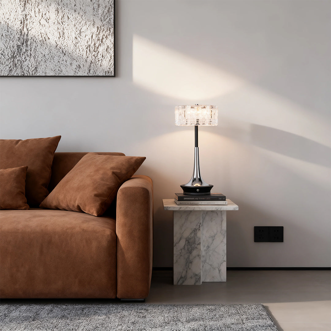 Elegant chrome and crystal cordless mushroom table lamp illuminating a modern living room with a brown velvet sofa. 