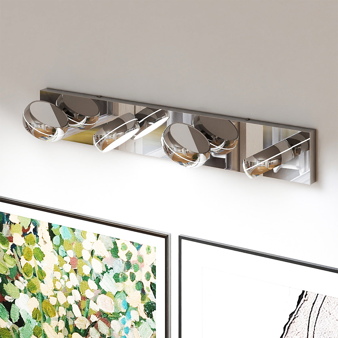 Elegant chrome bathroom vanity light featuring glass shade chandelier influence above botanical artwork in sophisticated setting.