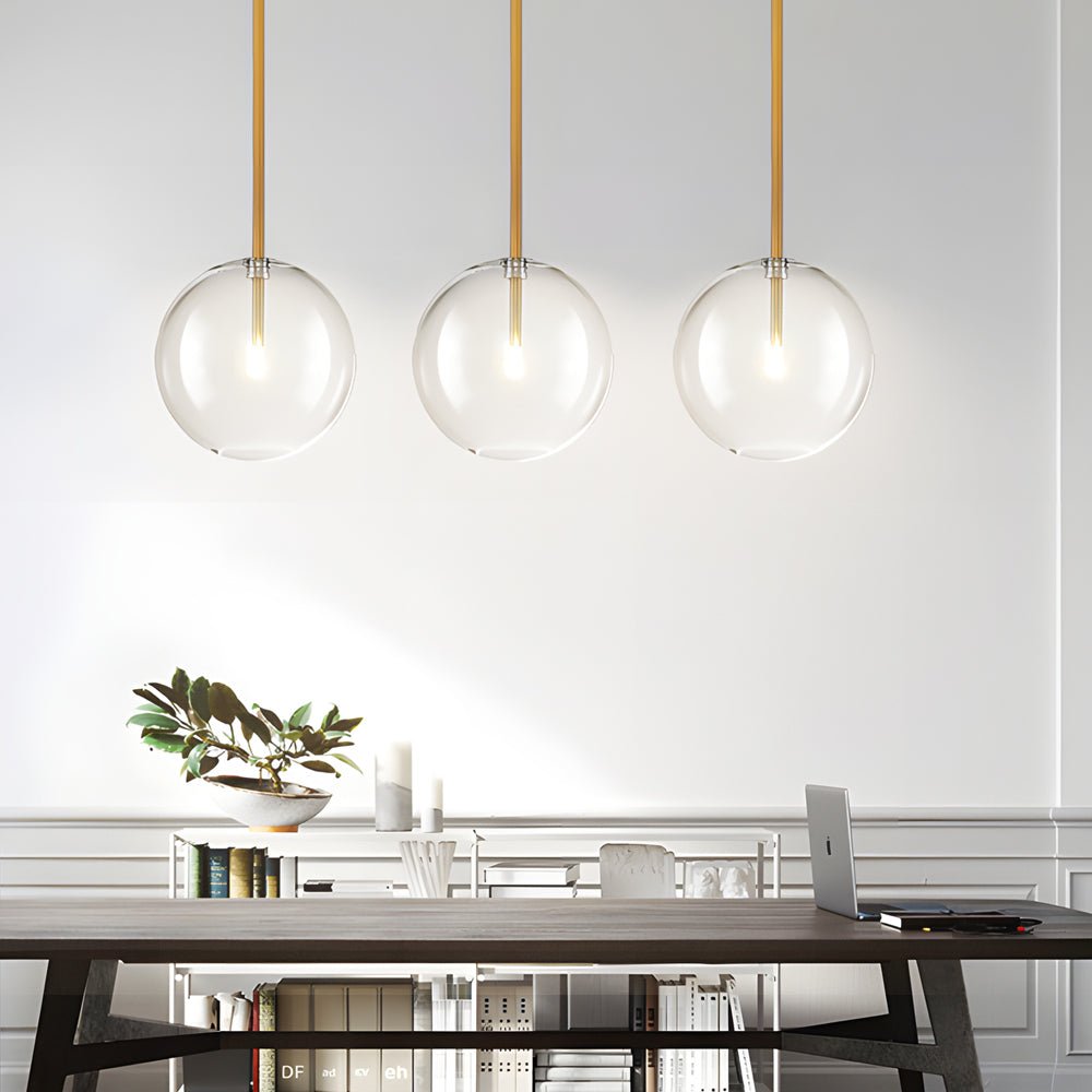 Clear glass globe pendant light in a bright, neutral space, showcasing a perfect balance of elegance and simplicity.