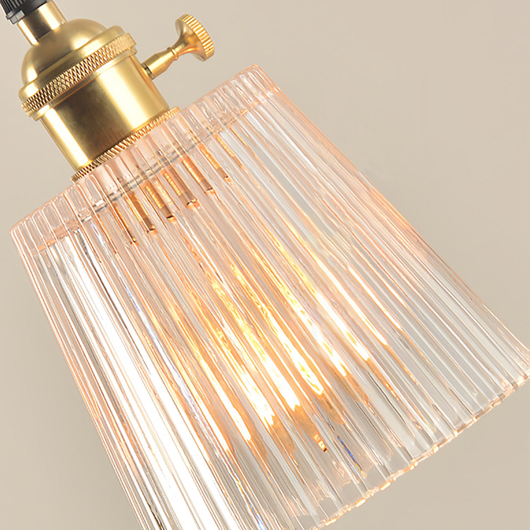 Elegant clear glass pendant light with detailed ribbed pattern and vintage brass hardware