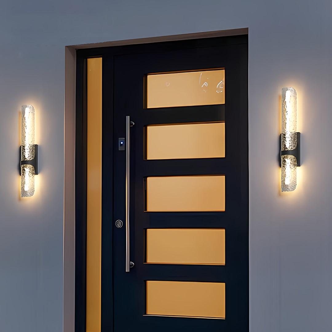 Elegant contemporary black outdoor wall lights with bubble glass flanking a modern black front door.