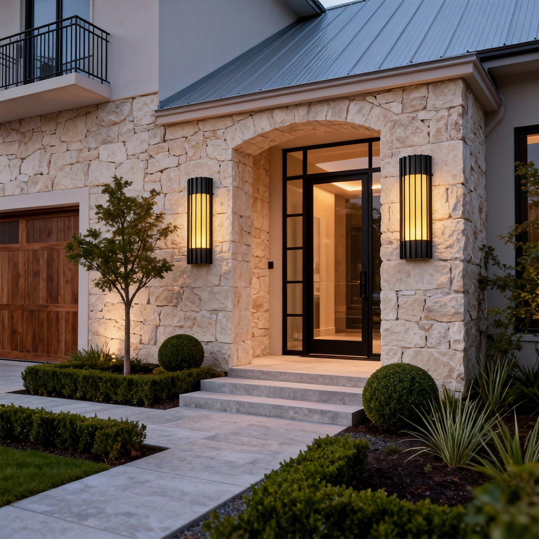 Elegant copper outdoor wall lights mounted on a stone facade, adding charm and sophistication to the entrance.