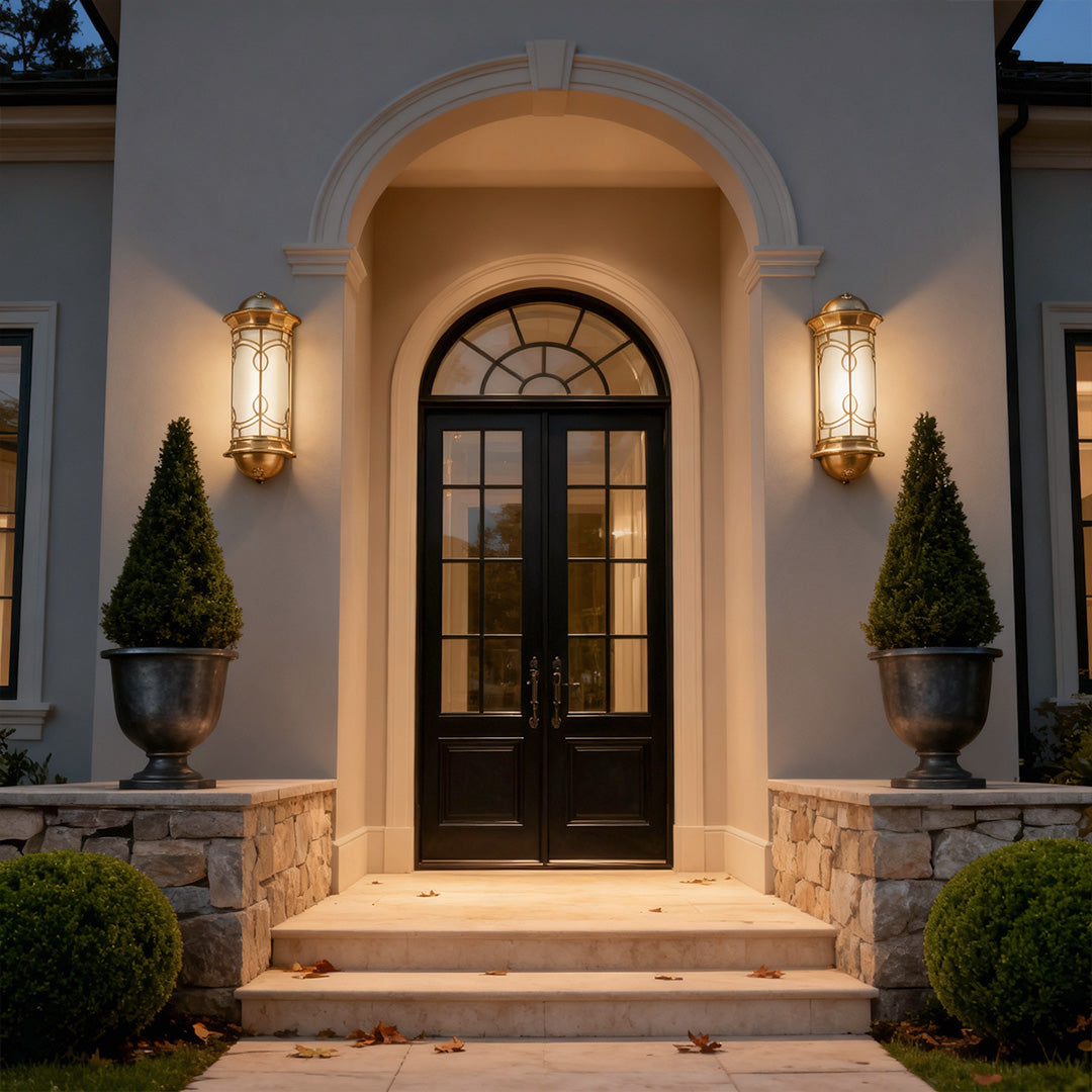 Elegant copper outdoor wall sconce enhancing a white facade, offering soft and sophisticated outdoor lighting.