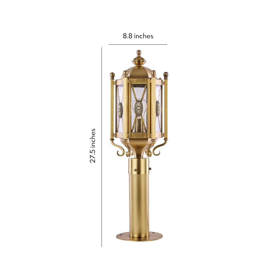 Elegant copper path light standing beside a green lawn, providing a cozy and welcoming atmosphere at night.