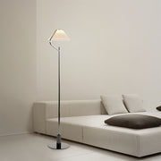Elegant craft floor lamp with a white fabric shade in a cozy living room