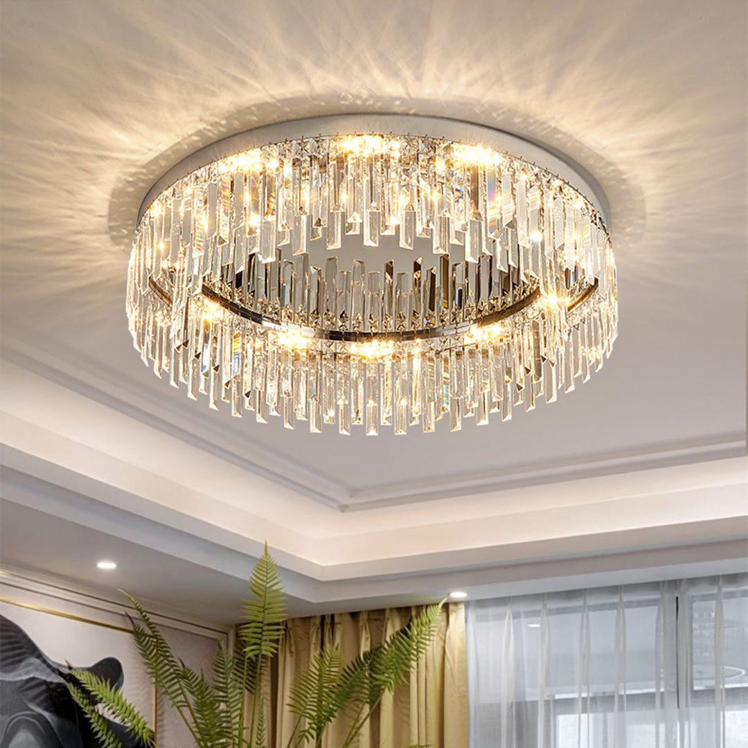 Crystal ceiling light creating warm ambient lighting in spacious room with plants