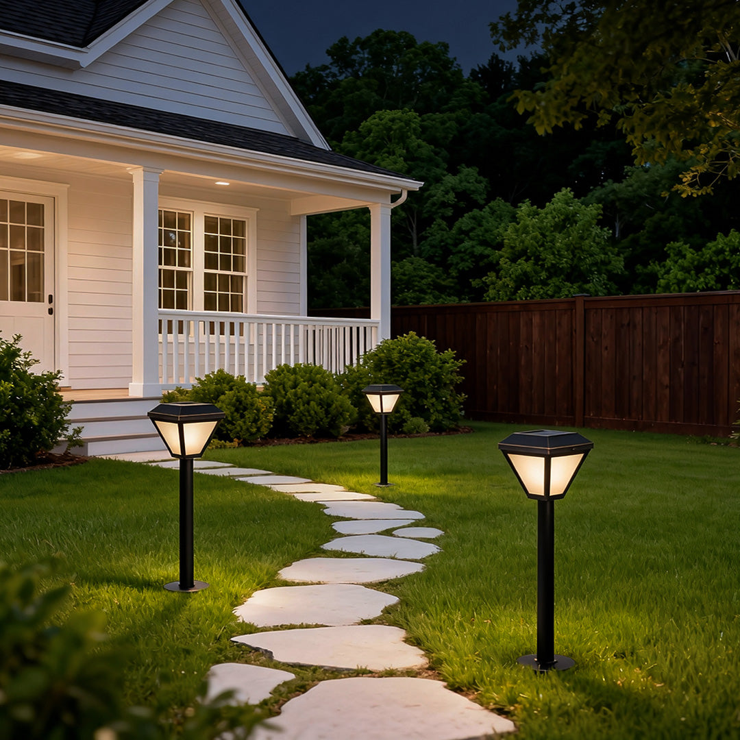 Elegant exterior path lighting guiding a serene garden path surrounded by lush greenery and flowers.