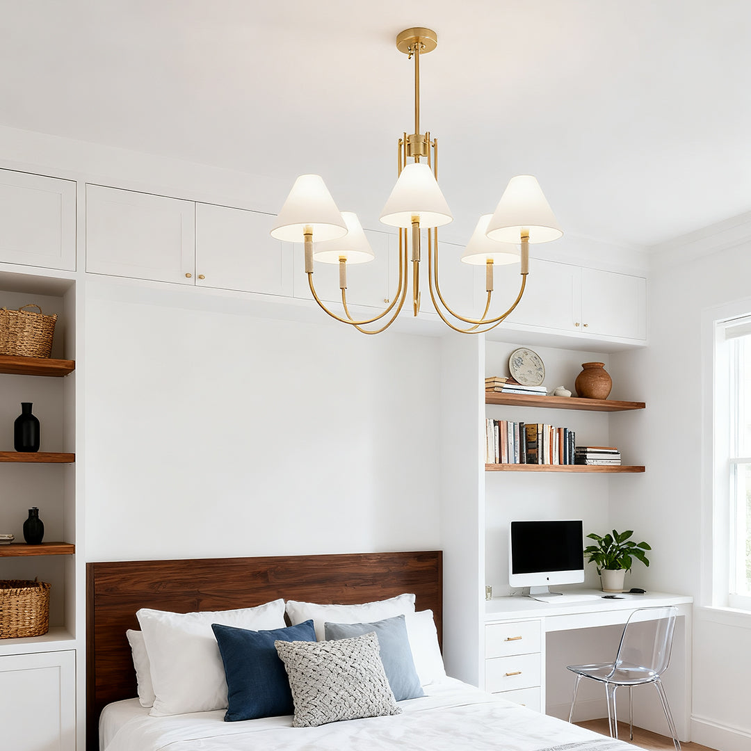 Minimalist bedroom and home office setting with an elegant five-arm cloth shade chandelier centered over the space.
