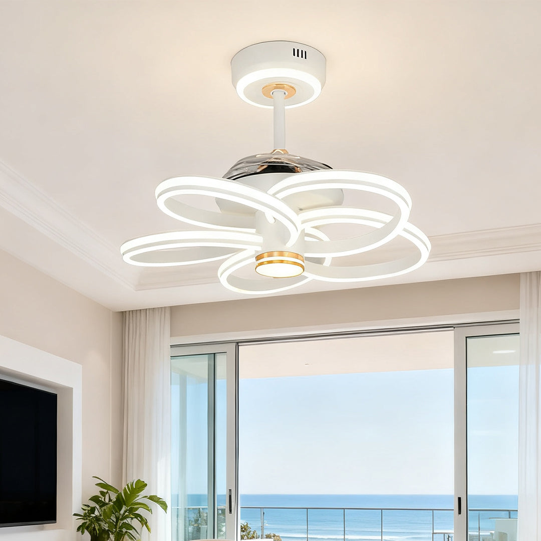 Elegant flower petal ceiling fans white with light fixture installed in a living area with large glass doors overlooking the ocean view. 