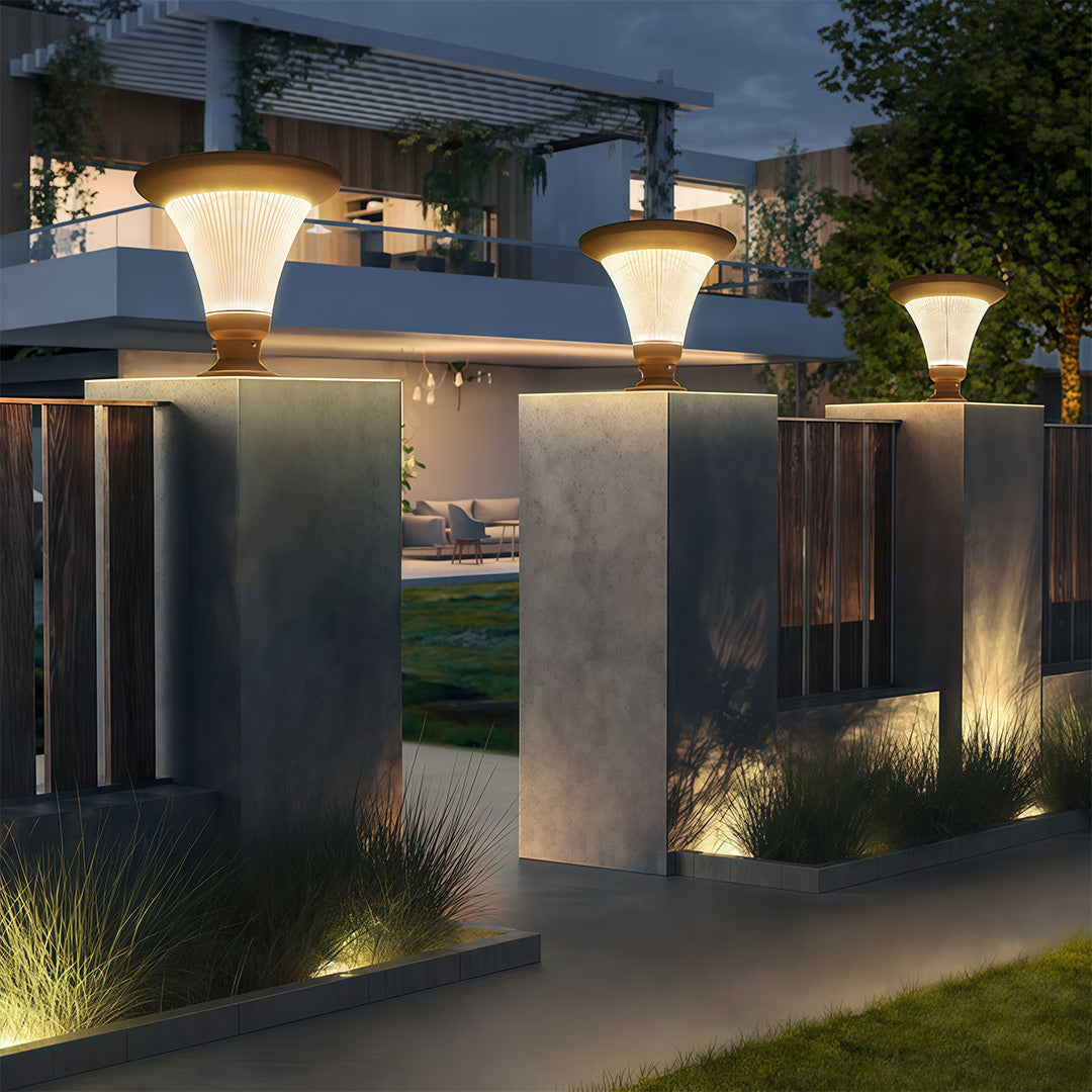 Elegant garden pillar light shining near the entrance of a luxurious property.