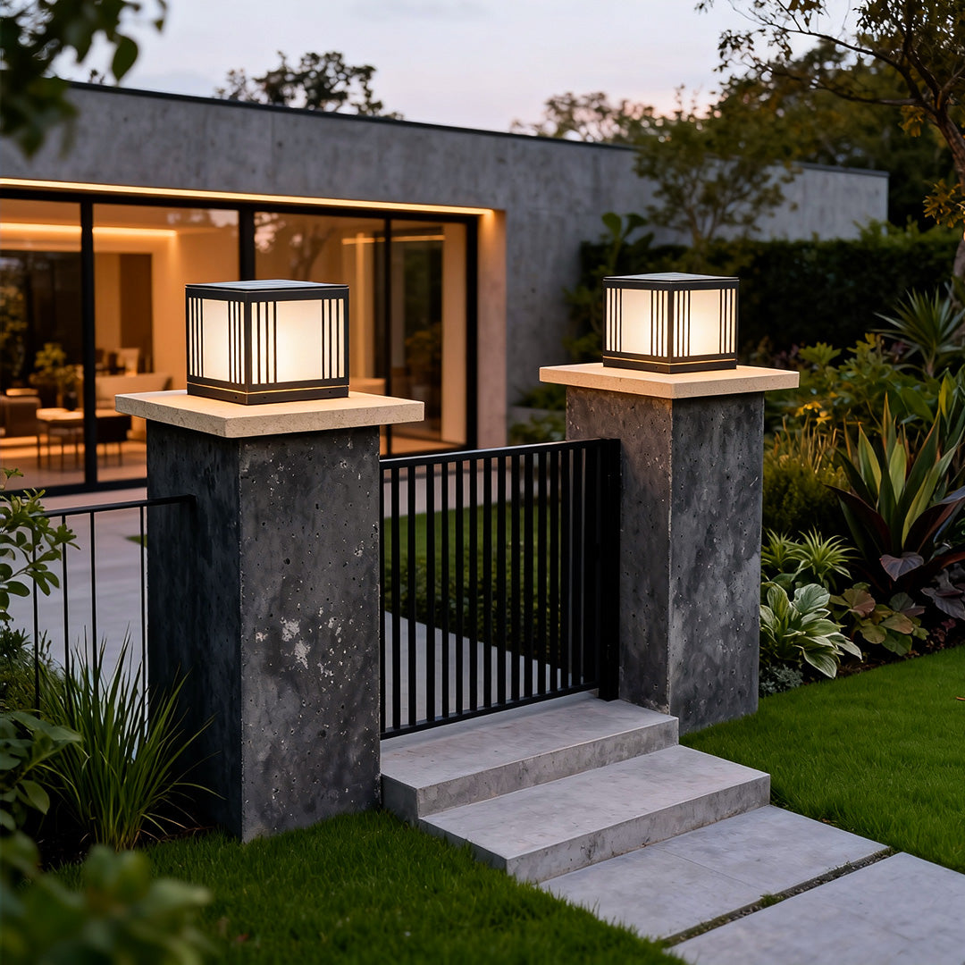 Elegant gate pillar solar light enhancing the entrance of a modern house with warm lighting.