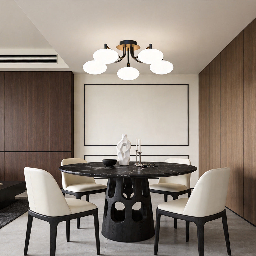 Elegant glass flush mount light fixture in a dining space with warm ambient lighting.