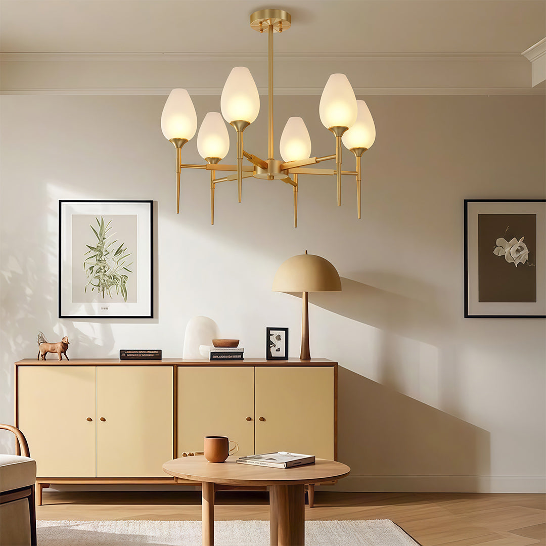 Elegant glass modern chandelier with glass shade chandelier design illuminating minimalist living space above wooden credenza.