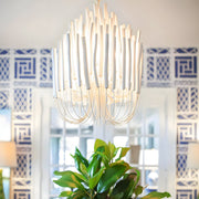 Elegant glass pendant chandelier hanging in a modern dining room, adding sophistication with its intricate design.