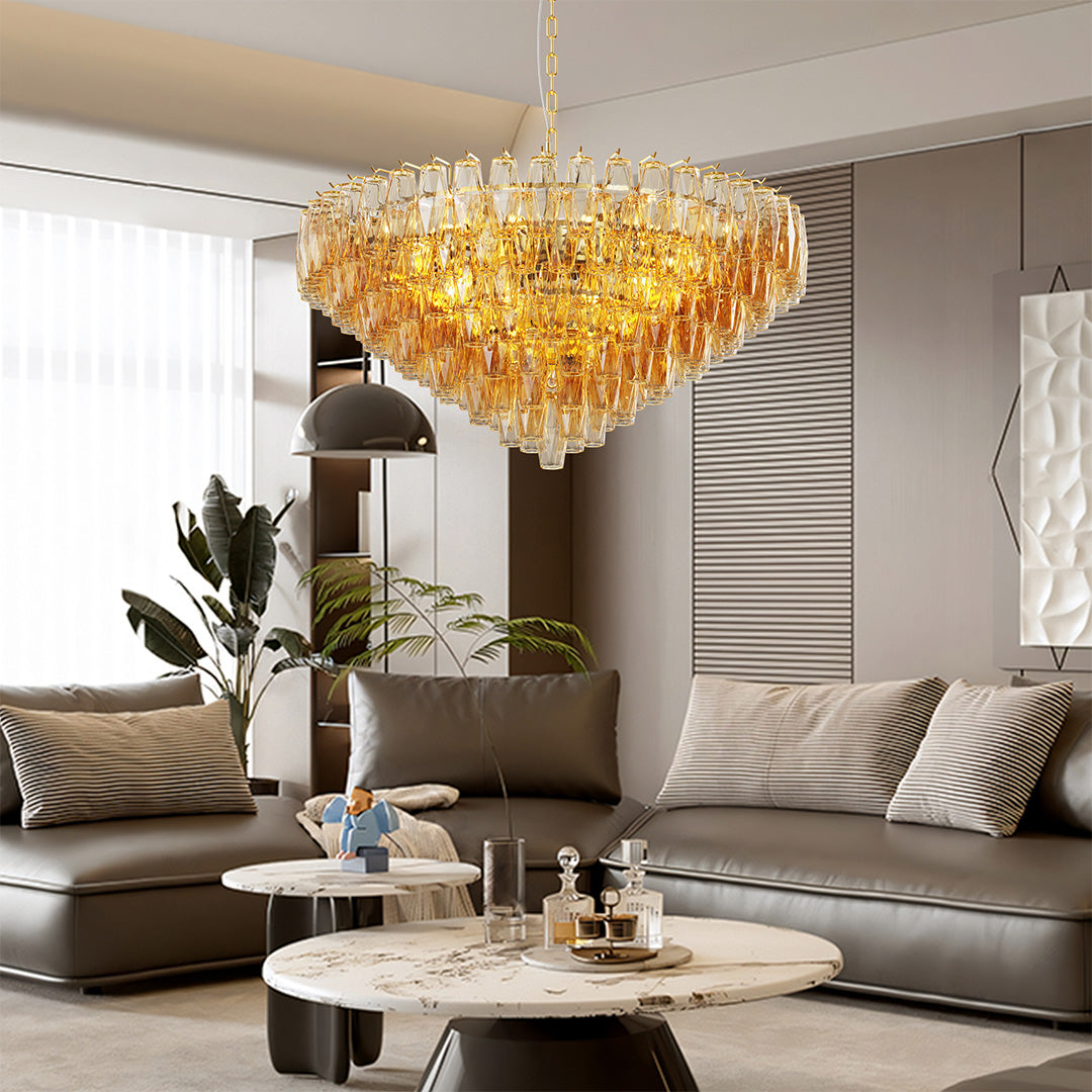 Elegant gold glass pendant chandelier illuminating a bright modern living room interior.