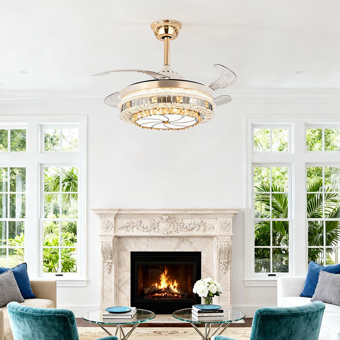 Elegant gold ceiling fan with light and crystal trim above a classic white fireplace 