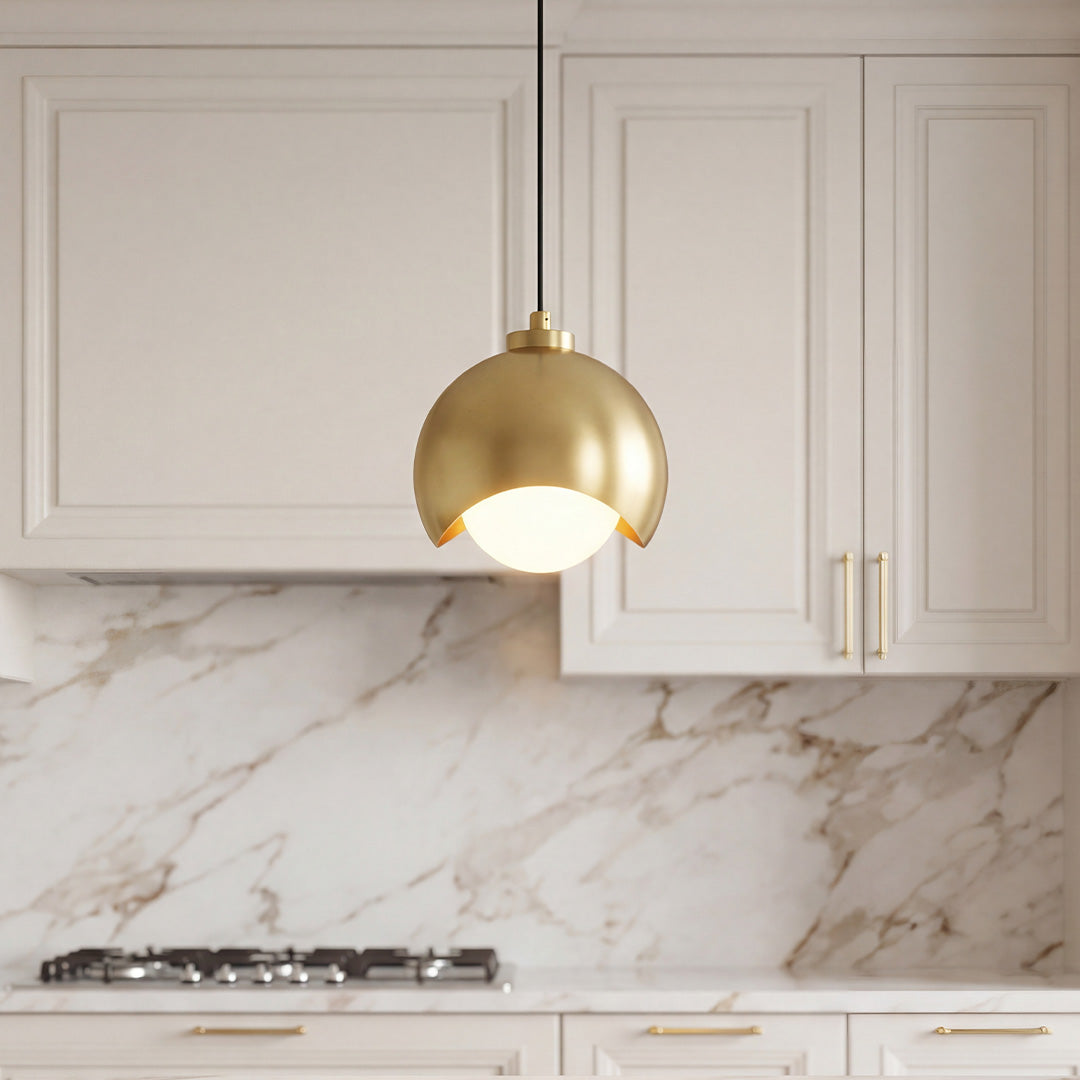 Elegant glass pendant light fixture with a gold crescent dome and a frosted opal glass globe.