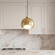 Elegant glass pendant light fixture with a gold crescent dome and a frosted opal glass globe.