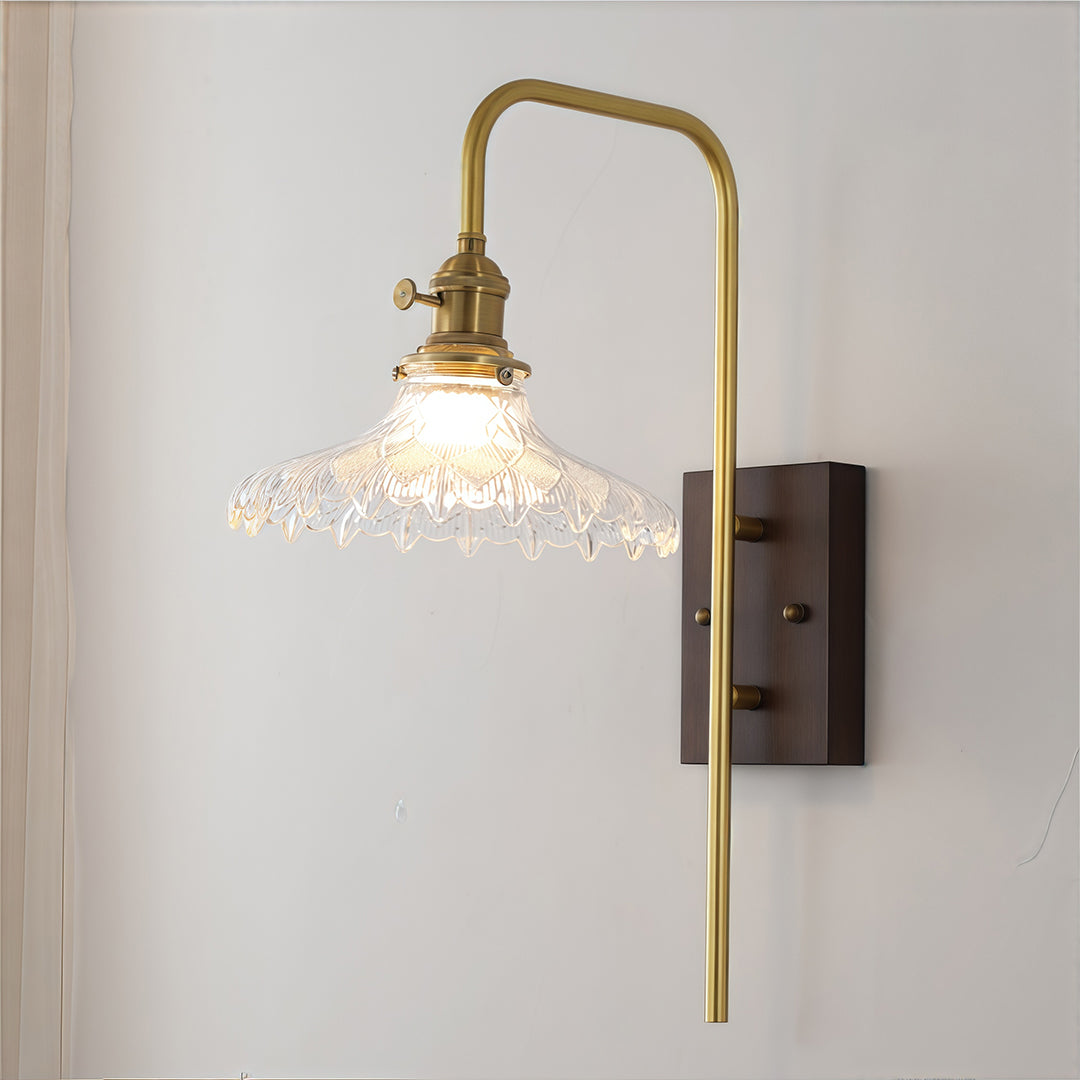 Elegant gold-finished glass wall lights with a delicate scalloped clear glass shade, offering subtle accent lighting.