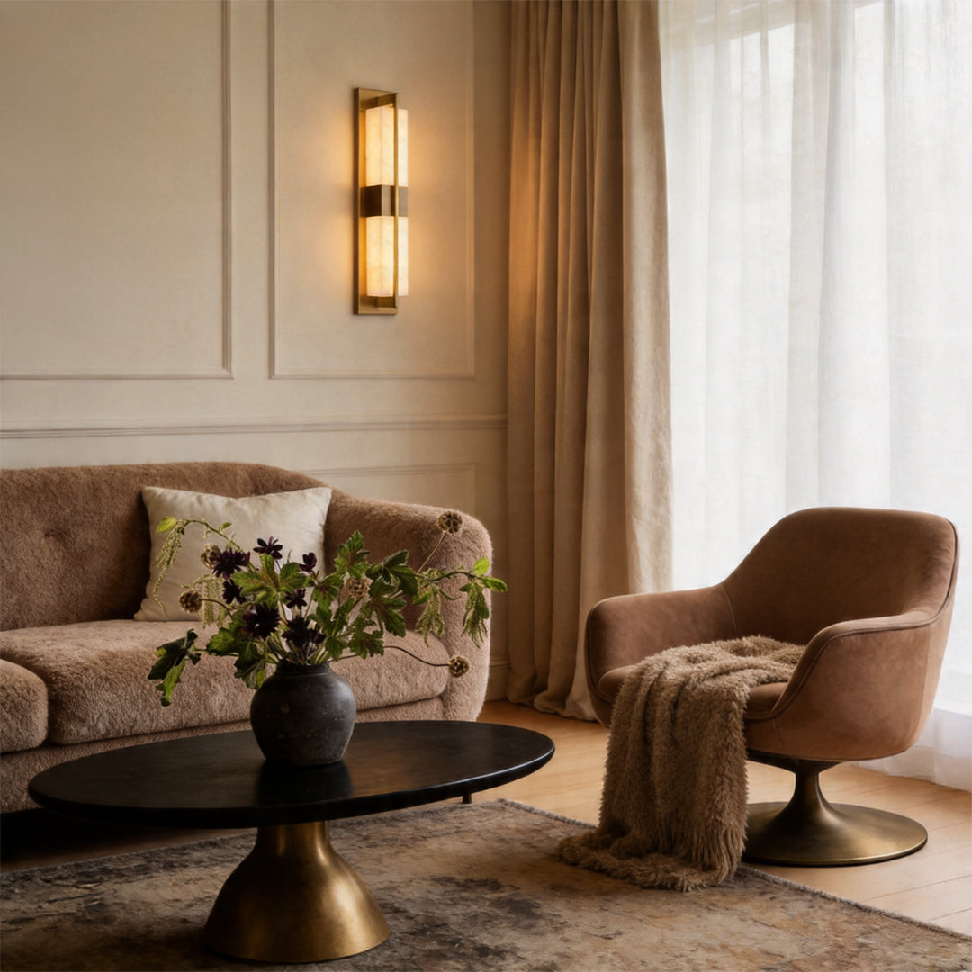 Elegant gold wall lighting glowing in a warm living room with cozy brown chairs and decor ok