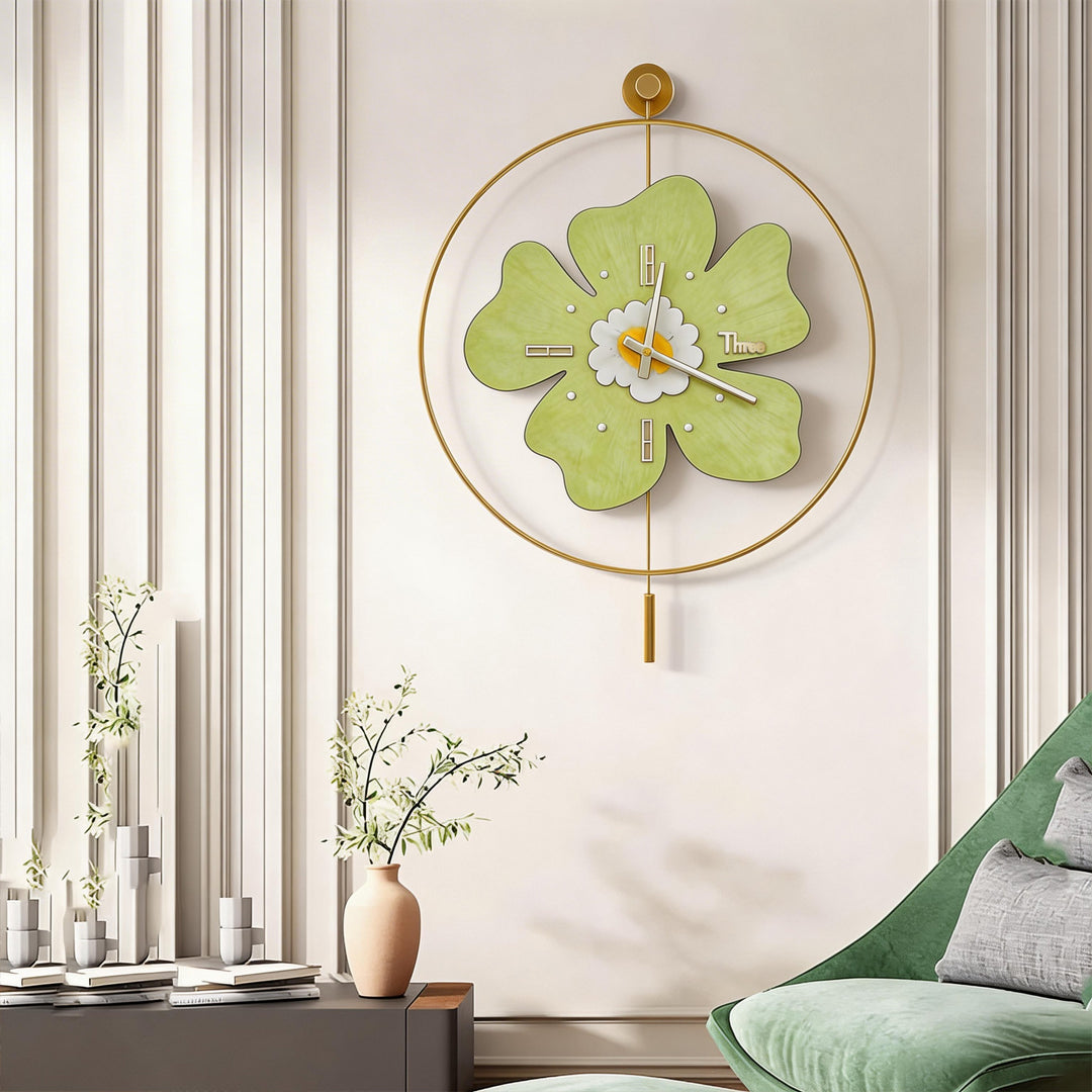 Elegant green wall clock with light hanging on a luxury white wall with moldings.