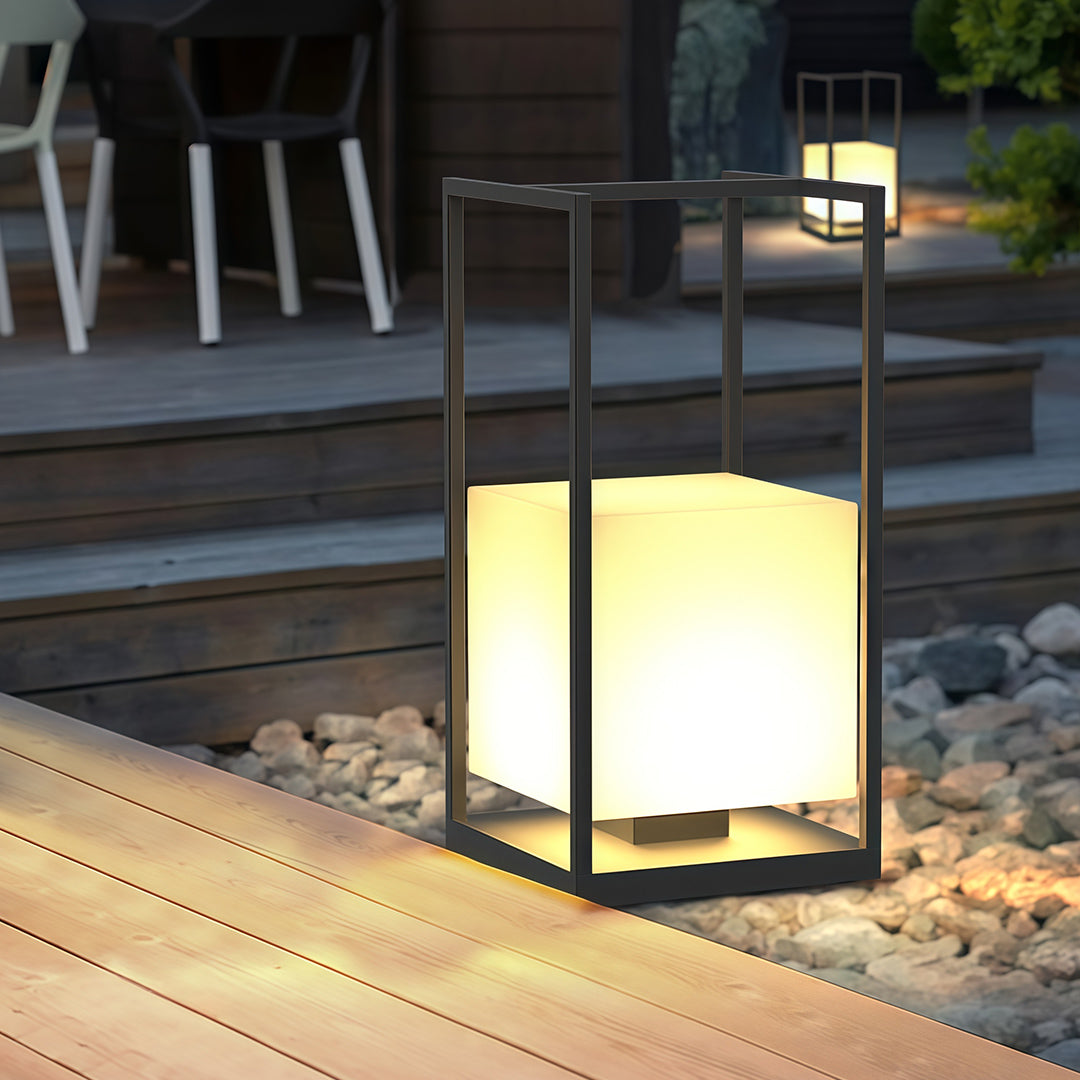 Contemporary outdoor lantern with a black metal frame, providing elegant illumination for outdoor spaces.