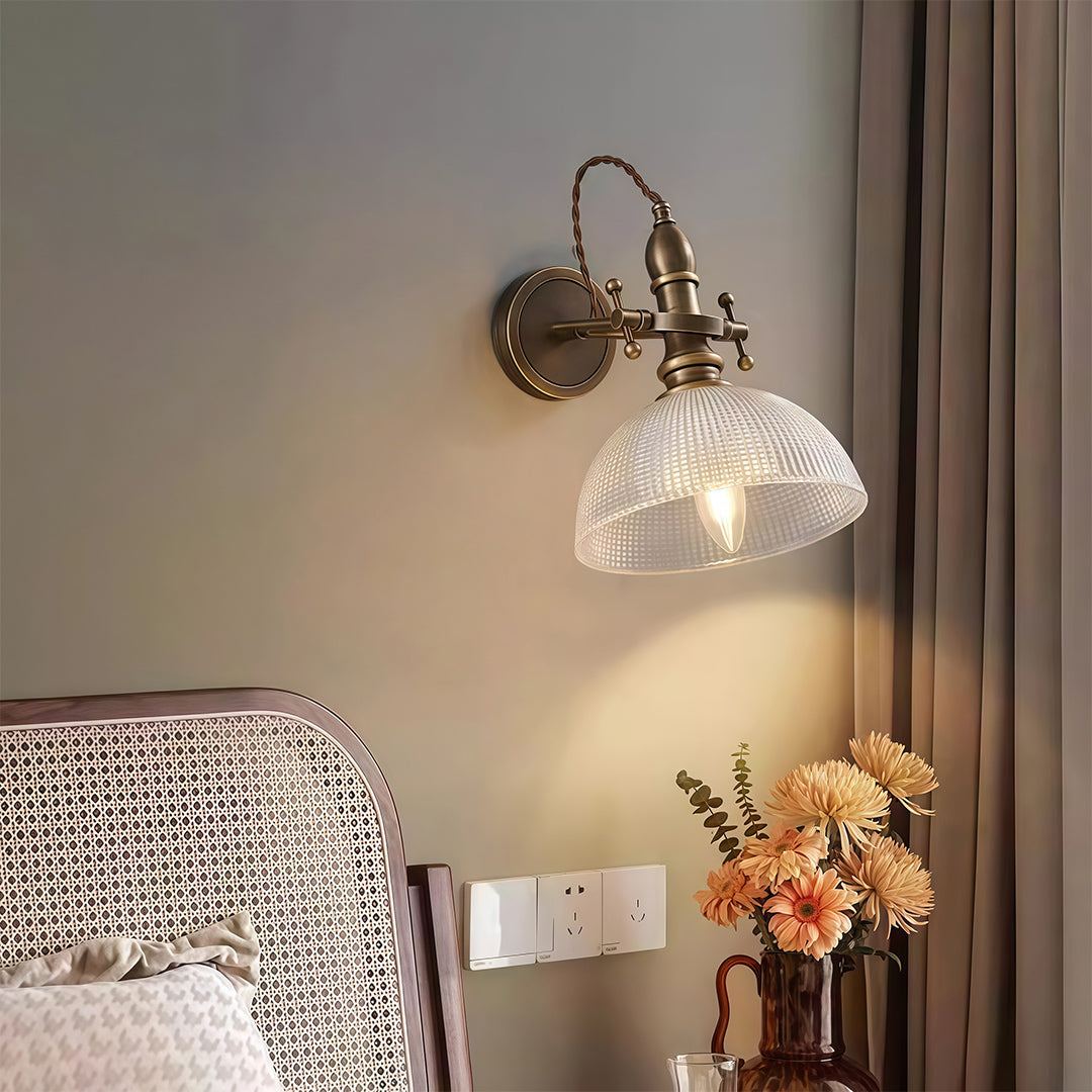 Elegant indoor wall mount lights featuring glass shade chandelier design illuminating bedroom above headboard with warm ambient glow.