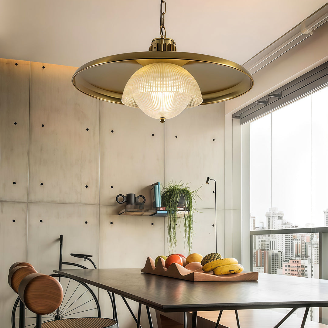 Elegant iron pendant light fixture over dining area with golden brass finish in contemporary open-plan space