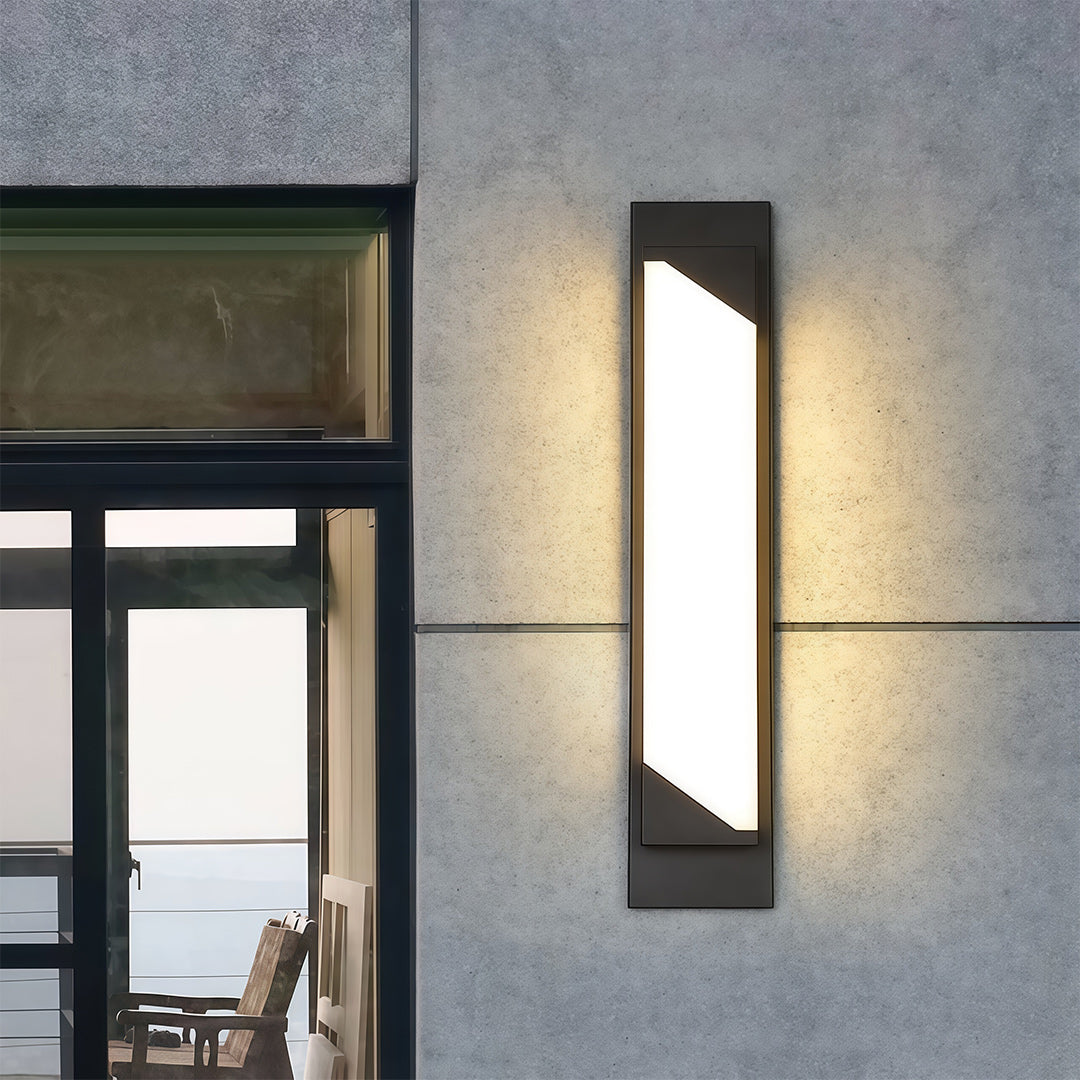 Elegant linear wall light outdoor featuring glass shade chandelier styling flanking entrance door in contemporary garage setting.