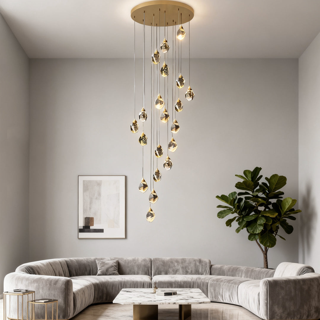 Elegant luxury staircase chandelier with cascading crystal droplets, illuminating a modern living room.