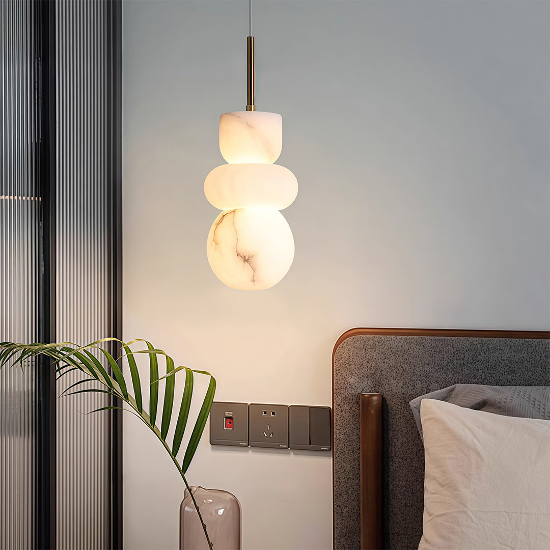 Elegant minimalist pendant light featuring glass shade chandelier design in large tiered configuration with warm translucent glow.