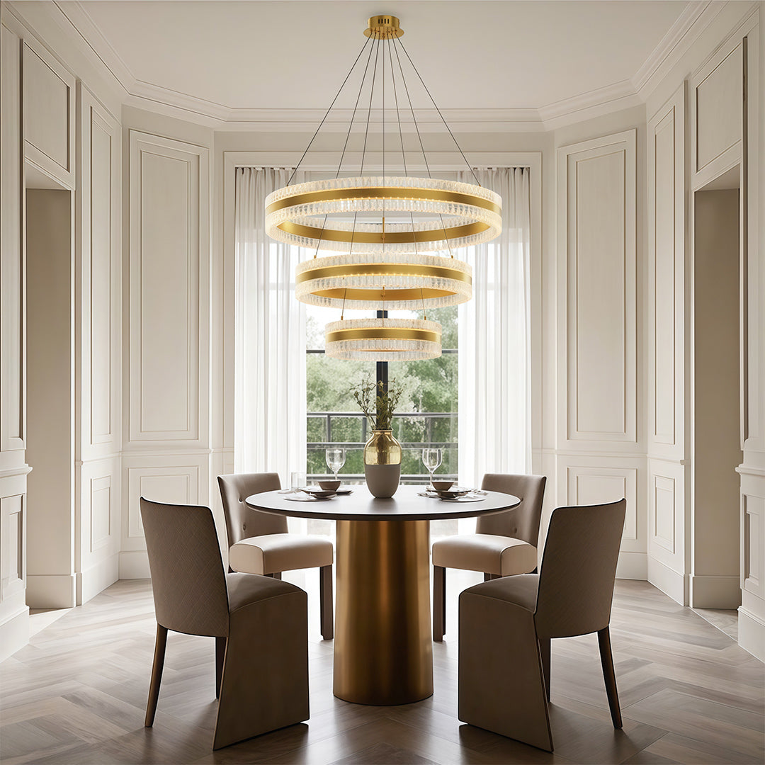Elegant modern circular chandelier with a gold finish, illuminating a stylish dining room.