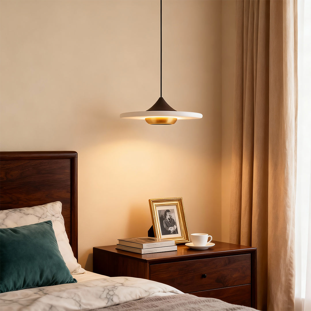 Elegant modern LED pendant lights with glass shade chandelier styling illuminating bedroom nightstand with warm ambient downlighting.