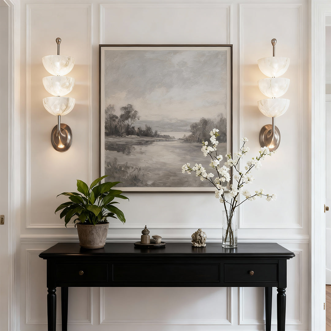 Elegant modern LED wall lights featuring glass shade chandelier styling illuminating traditional console with landscape art above.