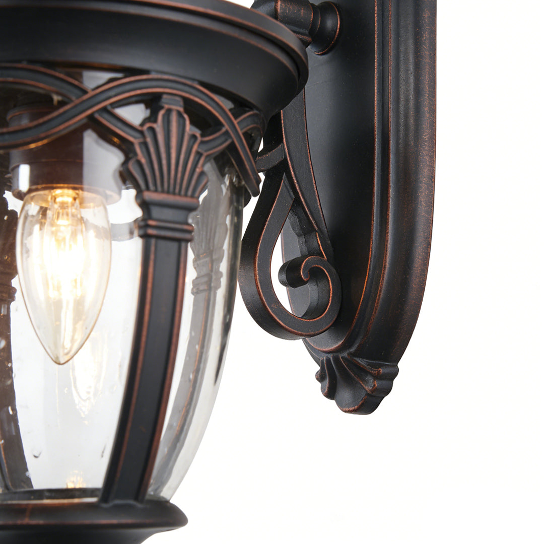 Elegant unique outdoor sconces with ornate bronze frame and ribbed glass, ideal for stylish and sophisticated outdoor lighting.