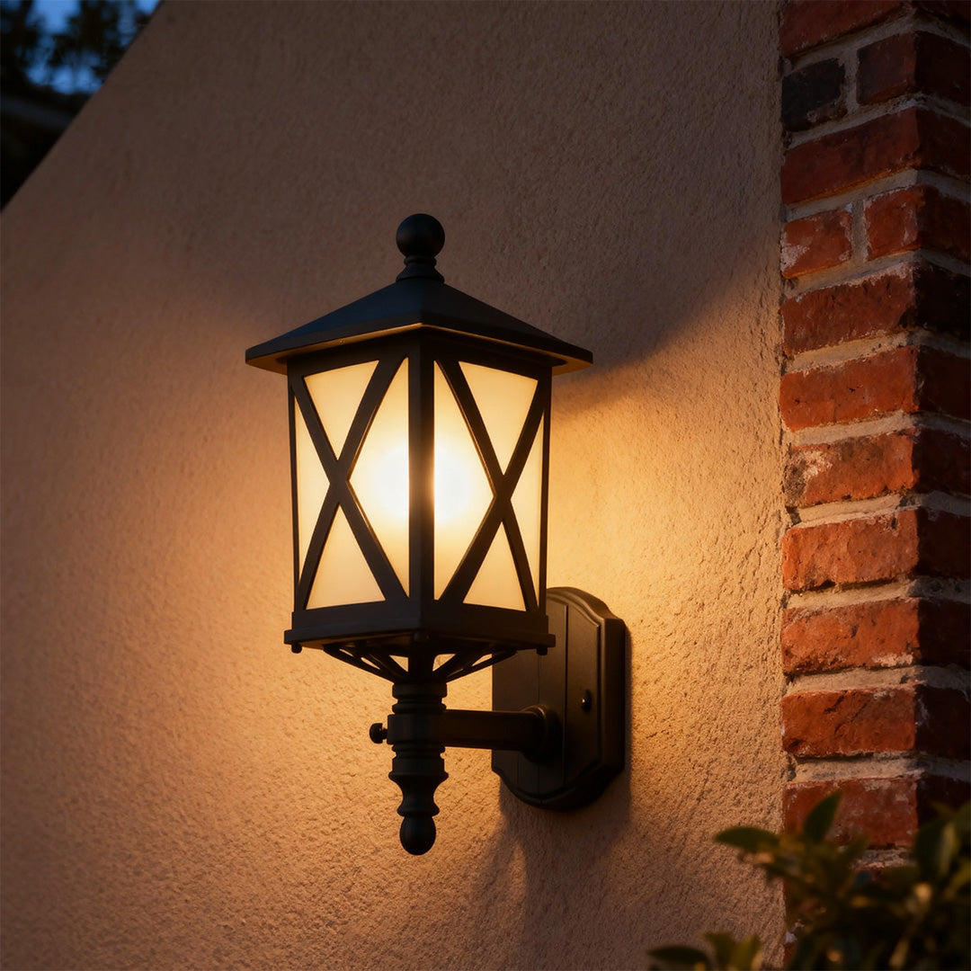 Elegant outdoor black wall light with amber glow mounted on dark brown brick wall at evening