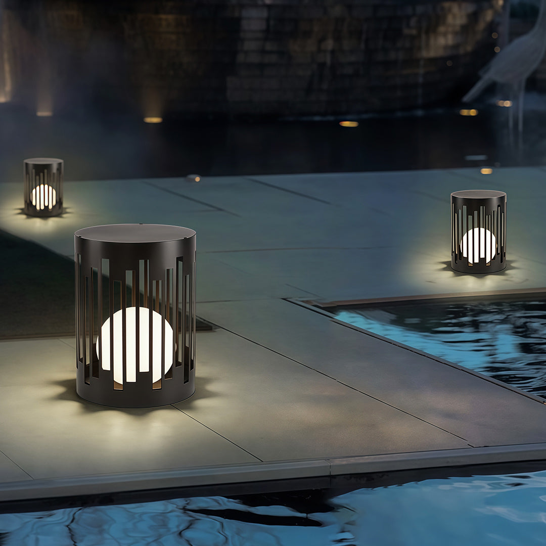 Elegant outdoor lantern light featuring glass shade chandelier styling creating ambient illumination on poolside deck at night.